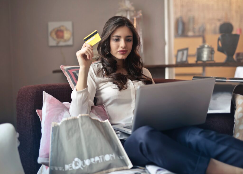 woman shopping on laptop holding credit card